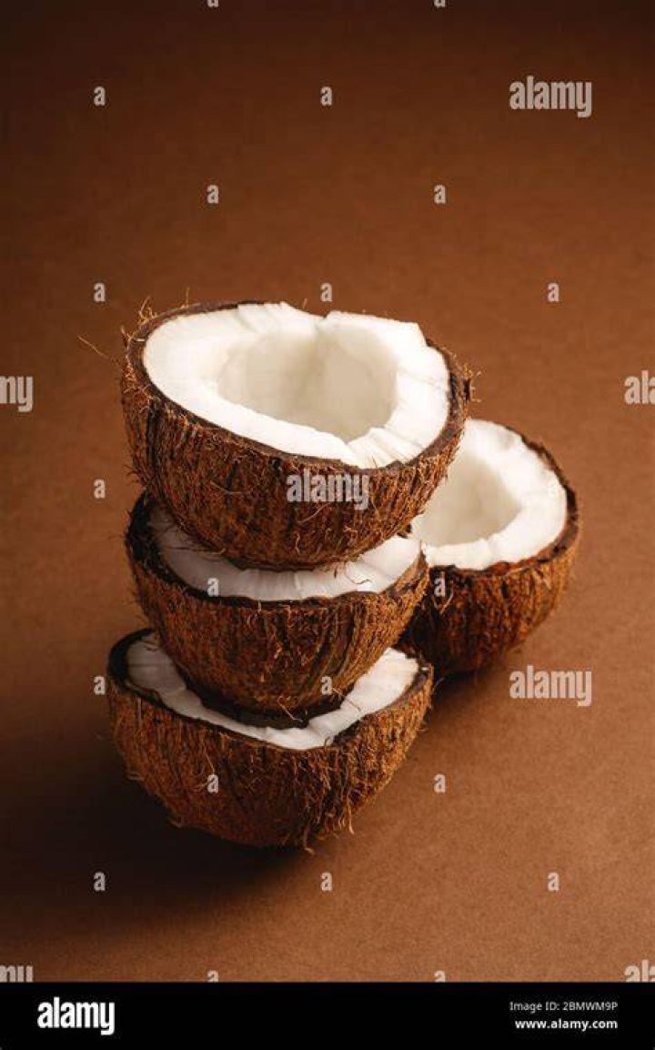 Coconut Fruits Stacked On Brown Wooden Surface &middot; Free Stock Photo