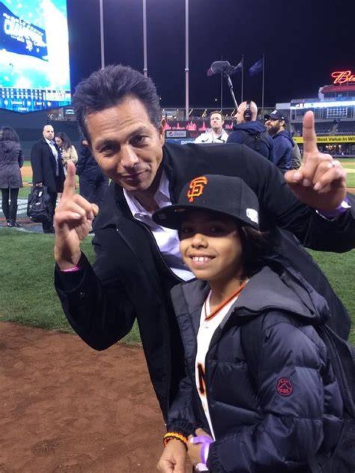  SFGiants fan Benjamin Bratt celebrates with his son